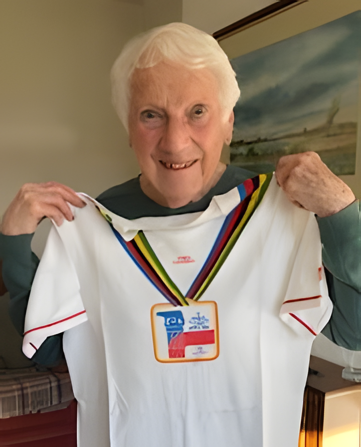 Image of Pam Horwill holding her World Championships T-Shirt